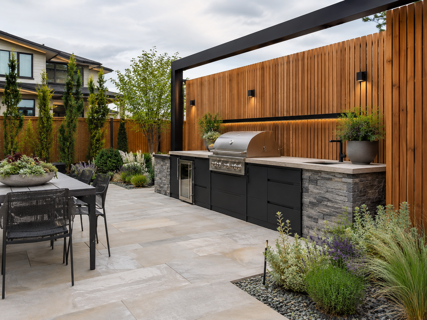 Modern landscaped courtyard with outdoor kitchen and cedar screening